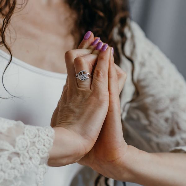 Close-up of hands in a graceful yoga mudra position.